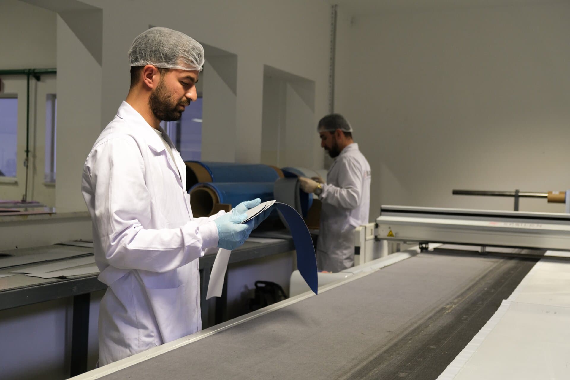 Factory assembly line with workers manufacturing composite parts